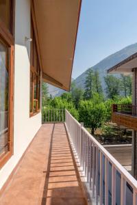 a balcony with a view of the mountains at Aurora, Stream view 3bhk Chateau by Roamhome in Kulu