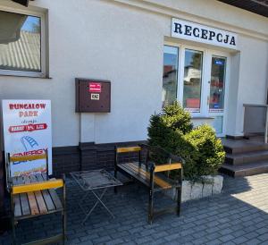 two benches sitting outside of a building at BUNGALOW PARK in Zator