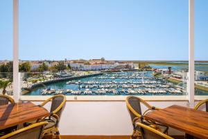 a view of a marina from a restaurant with tables and chairs at AP Eva Senses in Faro
