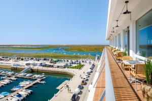 a view of a marina from the balcony of a hotel at AP Eva Senses in Faro