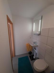 a small bathroom with a toilet and a sink at Eltinger Studio Apartment in Leonberg