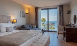 a hotel room with a bed and a balcony at Hotel Cliff Belvedere in Izola +37 photos