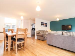 a living room with a table and a couch at 11 Towan Valley in Truro
