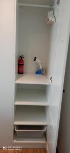 a white closet with white shelves in a room at Apartment Kleine Koje in Hedwigenkoog