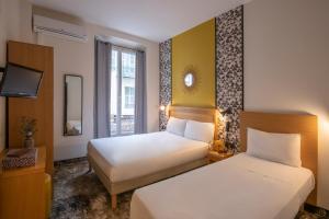 En eller flere senger på et rom på Hotel d'Ostende