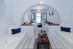a living room with two white couches and a table at DELION VIEW HOTEL in Fira