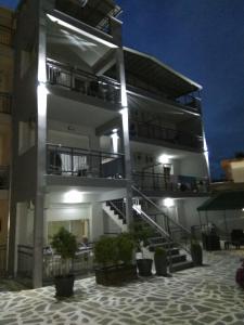 a building with stairs and potted plants in front of it at Studios Maria - Renovating Brand New for 2026 in Potos