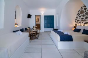 a living room with two beds and a couch at DELION VIEW HOTEL in Fira
