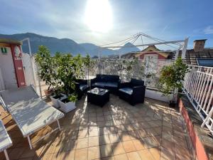 a balcony with couches and plants on a roof at The Secret Garden Relais in Piano di Sorrento