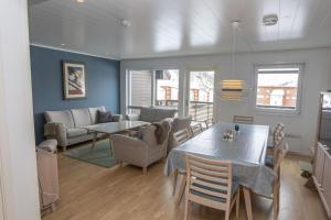a dining room and living room with a table and chairs at Four bedroom holiday cottage in Sirdal in Tjørhom