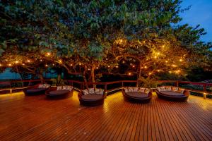 a wooden deck with benches and lights on a tree at Cassorova Resort e Ecoturismo in Brotas +15 photos