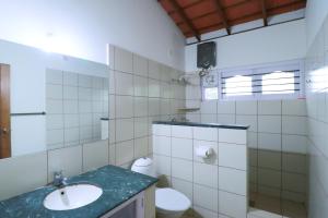 a bathroom with a sink and a toilet at SaffronStays Coorg Toddy Farms, Coorg in Madikeri +21 photos