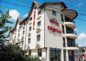 a large white building with a sign on it at Hotel Cristian in Afumaţi