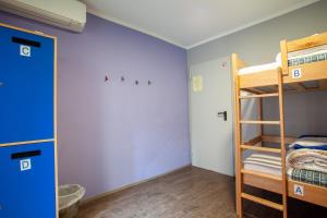 a bedroom with bunk beds and a closet at Hostel Adriatic Piran in Piran
