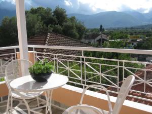 a balcony with a table and chairs and a view at Muses Studios Sami in Sami