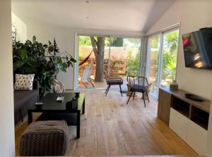a living room with a couch and a table and chairs at Une Oasis au Pays de Cézanne in Aix-en-Provence
