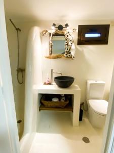 a bathroom with a sink and a toilet at Pistachio Guesthouse, Παραδοσιακός ξενώνας in Vathí
