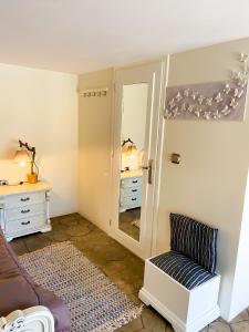 a living room with a mirror and a couch at Pistachio Guesthouse, Παραδοσιακός ξενώνας in Vathí