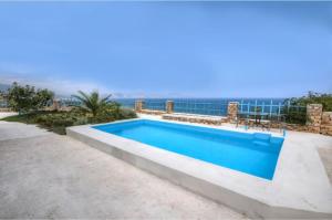 a swimming pool with a view of the ocean at Stone Villa II in Petres in Petres