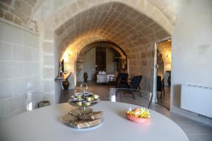 een witte tafel met een fruitschaal erop bij Suite San Placido in Matera
