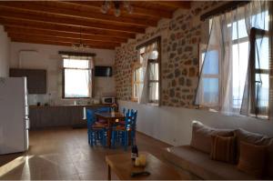 a living room with a couch and a table at Stone Villa I in Petres in Petres +16 photos