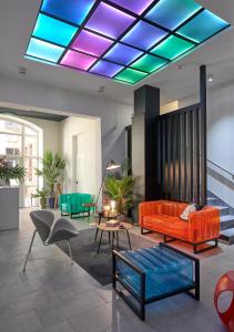 a living room with a couch and a table at Butik Art Hotel in Budapest