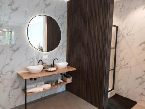 a bathroom with two sinks and a mirror at Saya Boutique Hotel in Amersfoort