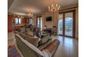 uma sala de estar com dois sofás e uma mesa em Amazing Villa Amare with stunning views em Amárion