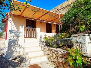 a house with stairs and a stone wall at Casa di Maria in Rethymno