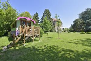 a play house in a field with a yard at Roulotte La Verdine in Dury
