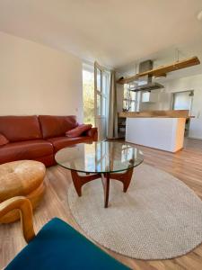 a living room with a couch and a glass table at Gronocottage in Bad Harzburg