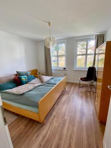 a bedroom with a bed and a chair in it at Gronocottage in Bad Harzburg