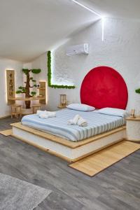 a bedroom with a large bed with a red headboard at REnt room Japaroom in Anguillara Sabazia