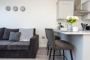 a living room with a couch and a kitchen counter at Modern Apartments in Kings Lynn with Free Wi-Fi in King's Lynn