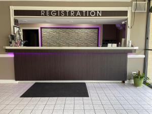 a restaurant with a purple counter in a building at Americas Best Value Inn - Wilson in Wilson