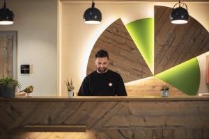 a man sitting at a counter in a restaurant at the niu Mill in Cologne