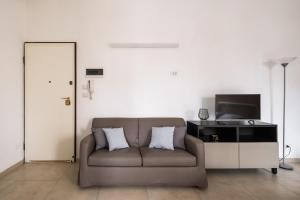 a living room with a couch and a flat screen tv at Palazzina Carracci in Bologna