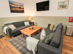 a living room with two couches and a coffee table at The Bakery in Belford