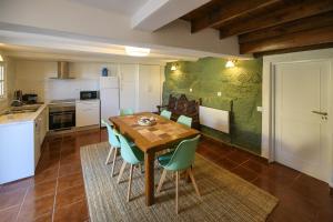 a kitchen and dining room with a wooden table and chairs at Majestic Villa in Amarante with Private Pool in Amarante