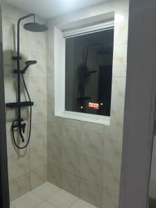 a shower with a window in a bathroom at 999 Hotel in Angeles