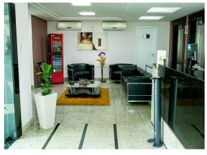 a living room with couches and a coffee table at Steel Valley Hotel in Ipatinga