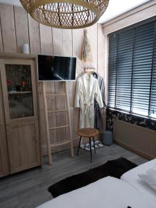 a bedroom with a mannequin and a tv in a room at Sweetlake in Zoetermeer