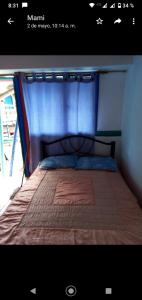 a bed with a blue cover on top of it at Casa de Campo La Prosperidad in Bobadilla