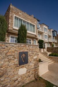 a brick building with a sign in front of it at Vinifera Ephesus Hotel in Selcuk