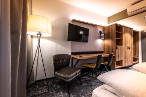 Postel nebo postele na pokoji v ubytování EGINO-Premium Hotel, Restaurant & Bar