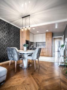 a kitchen with a table and two chairs at The Boulevard Luxury Apartment in Sofia
