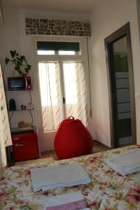 a bedroom with a bed with a red ball on the floor at Venezia lovely rooms in Venice-Lido