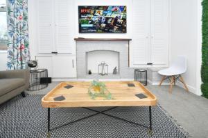 a living room with a coffee table in front of a fireplace at London House by YourStays in Stoke on Trent