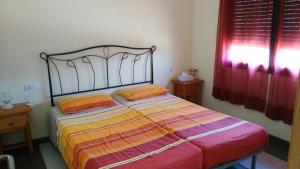 a bedroom with a large bed with orange pillows at La Pallissa 9 in Torroella de Montgrí