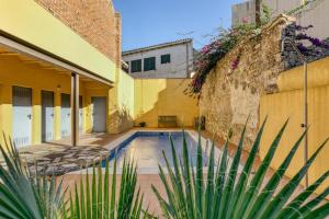 a swimming pool in the courtyard of a building at Ground floor apartment in Centre of Torroella De Montgri in Torroella de Montgrí